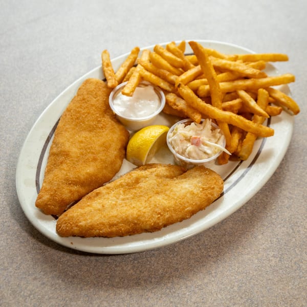 Two pieces of fried fish, a pile of french fries, tartar sauce, coleslaw, and a lemon wedge.